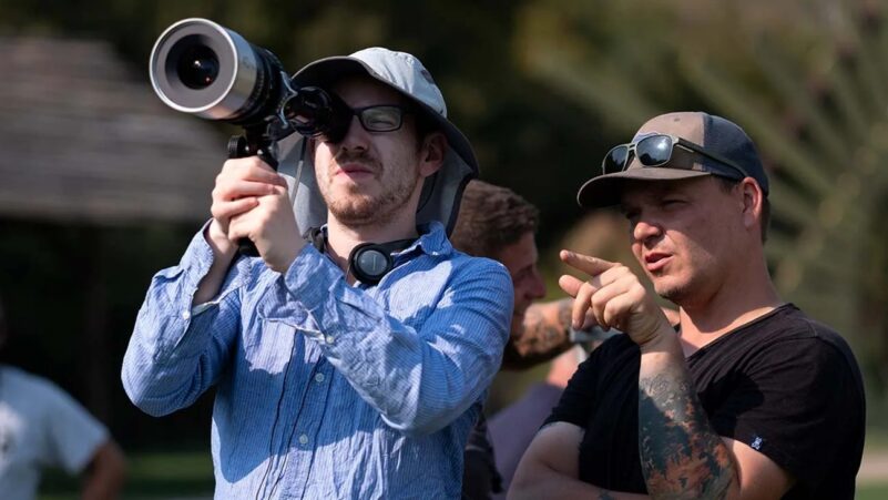 Ari Aster holding a camera on the set of Midsommar