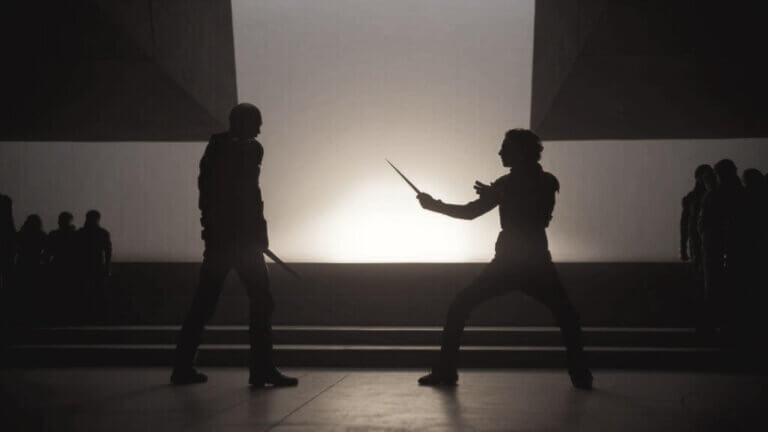 Paul Atreides and Feyd-Rautha prepare for a duel at sunset