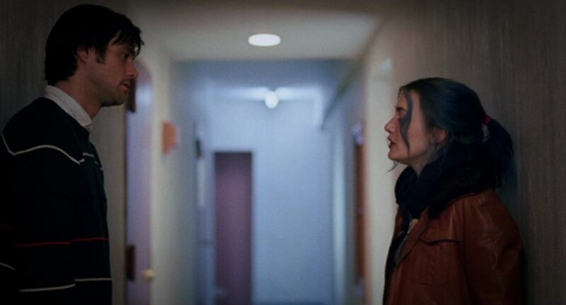Joel and Clementine look at each other in the hallway