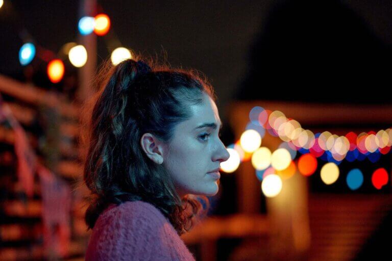 Sam stares off during a party.