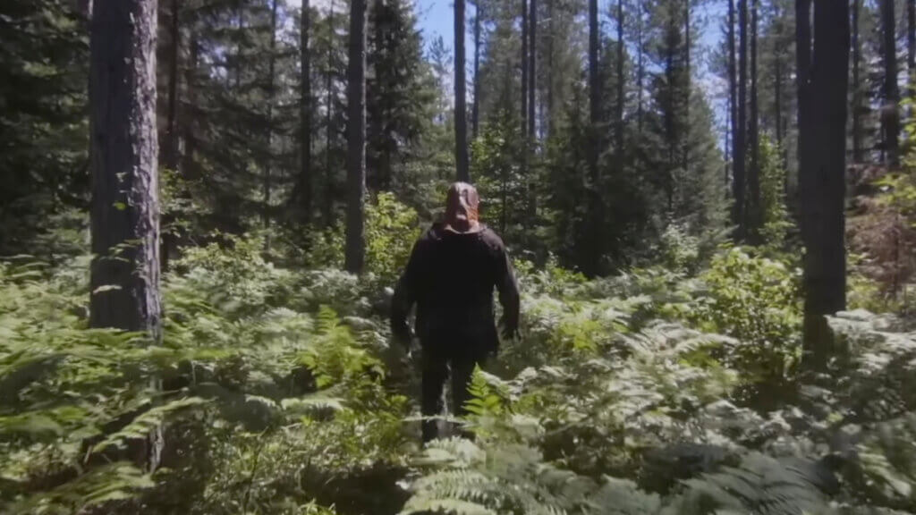 Johnny trudges through the forest