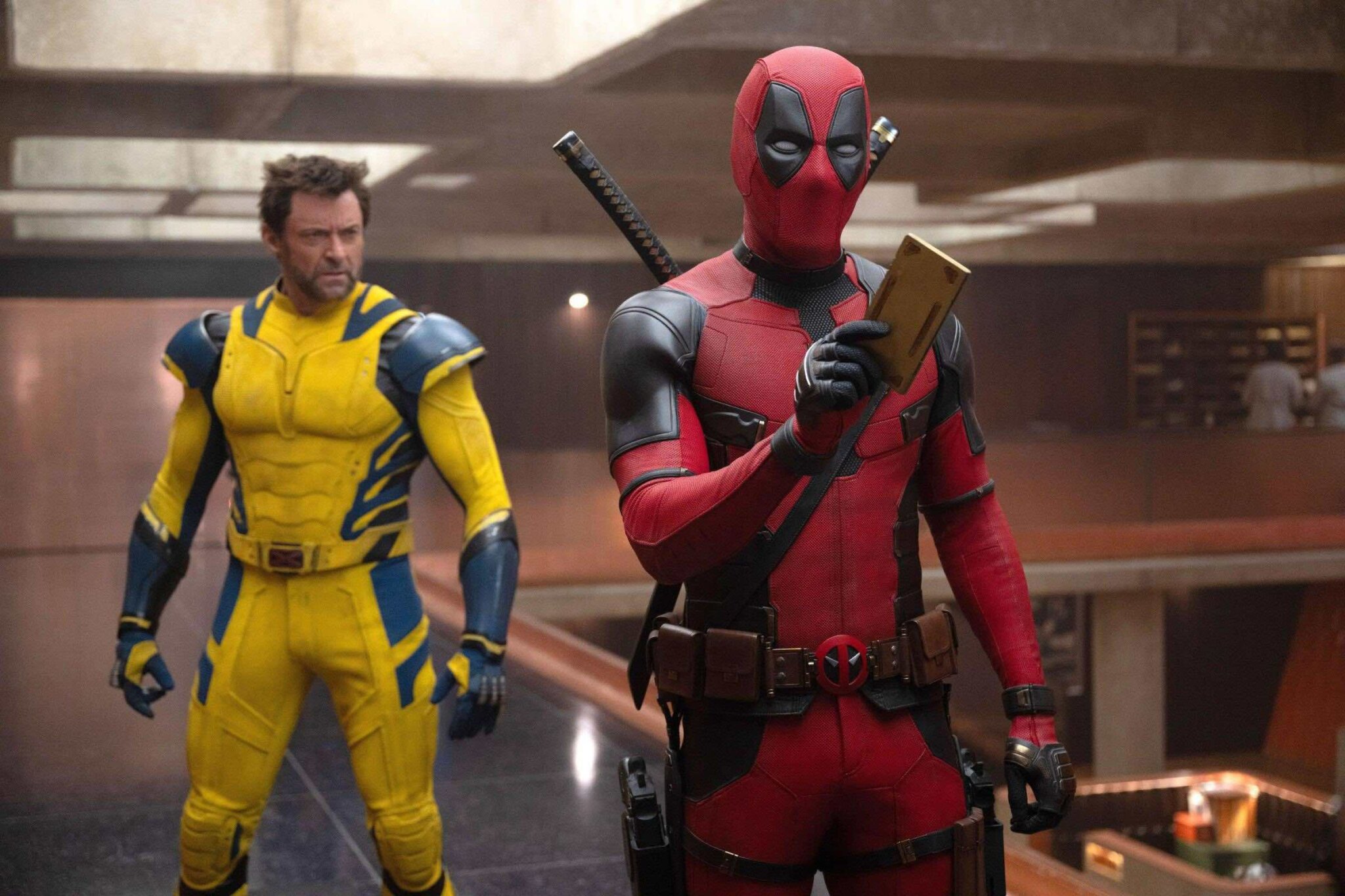 Deadpool and Wolverine in an office building