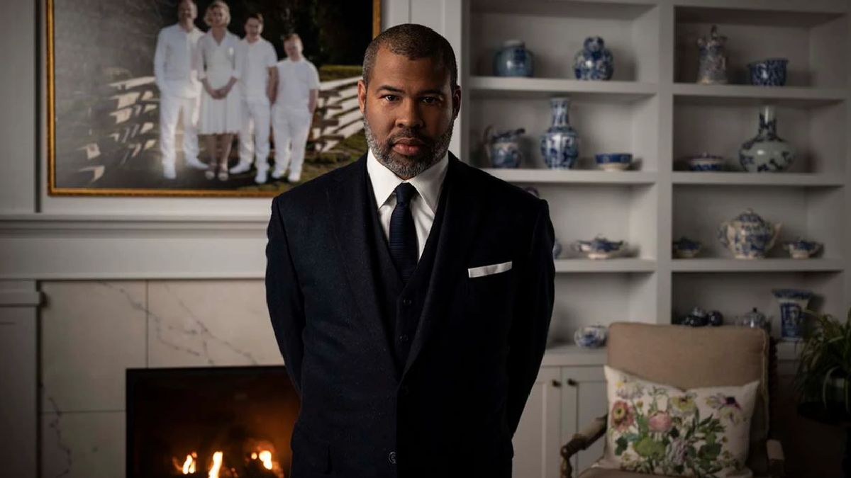 Jordan Peele stands in a fancy living room