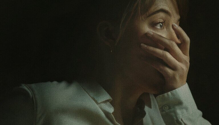 Lee Harker covers her mouth in horror