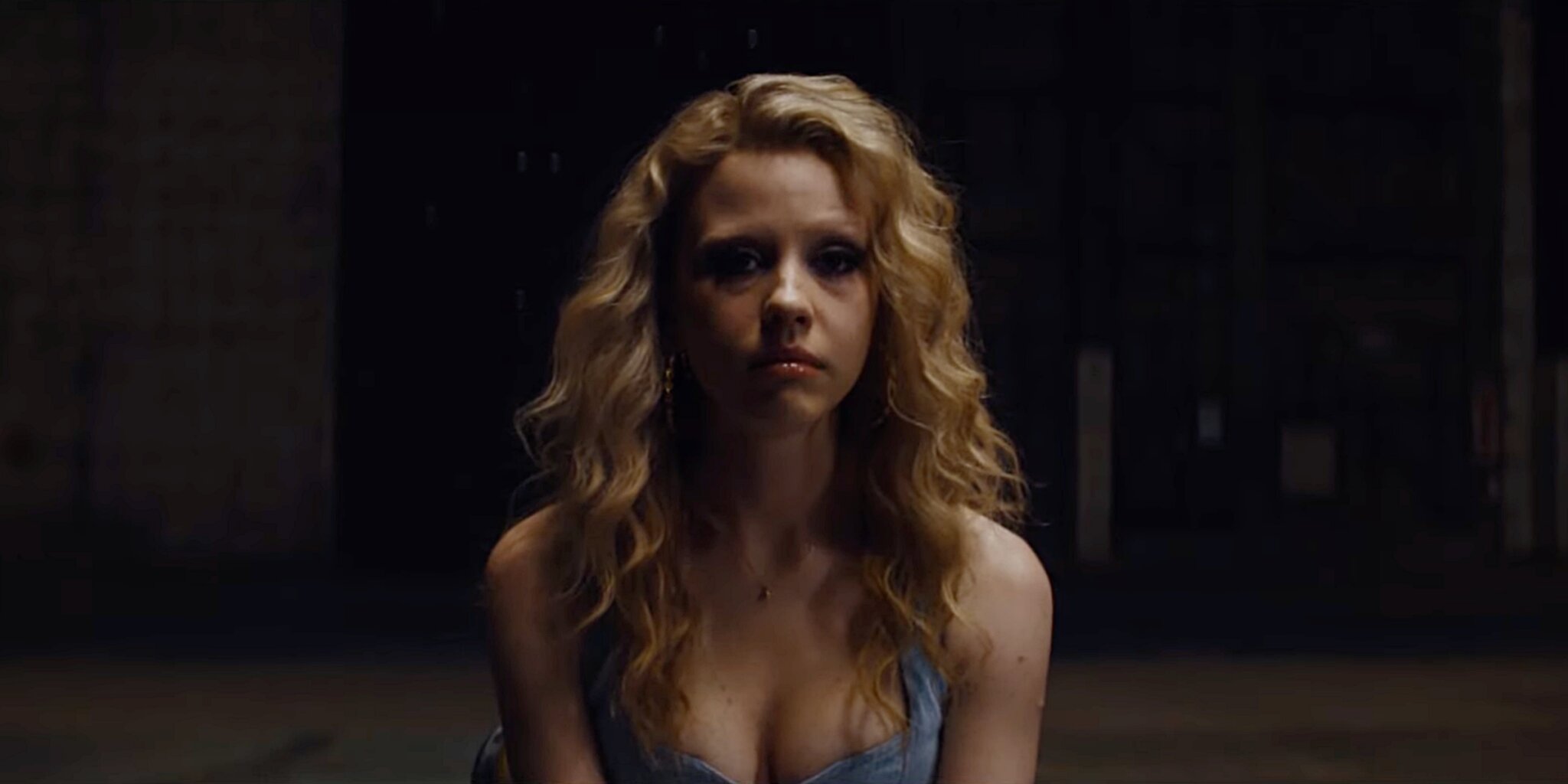 Maxine sits and looks into an imaginary camera during an audition