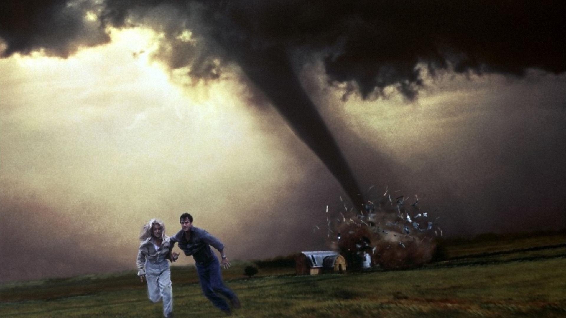 Jo and Bill run from a giant tornado that tears through a house behind them