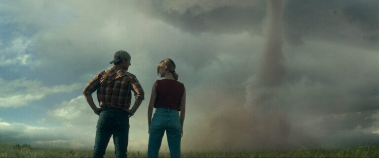 Tyler and Kate talk while a tornado churns in the distance