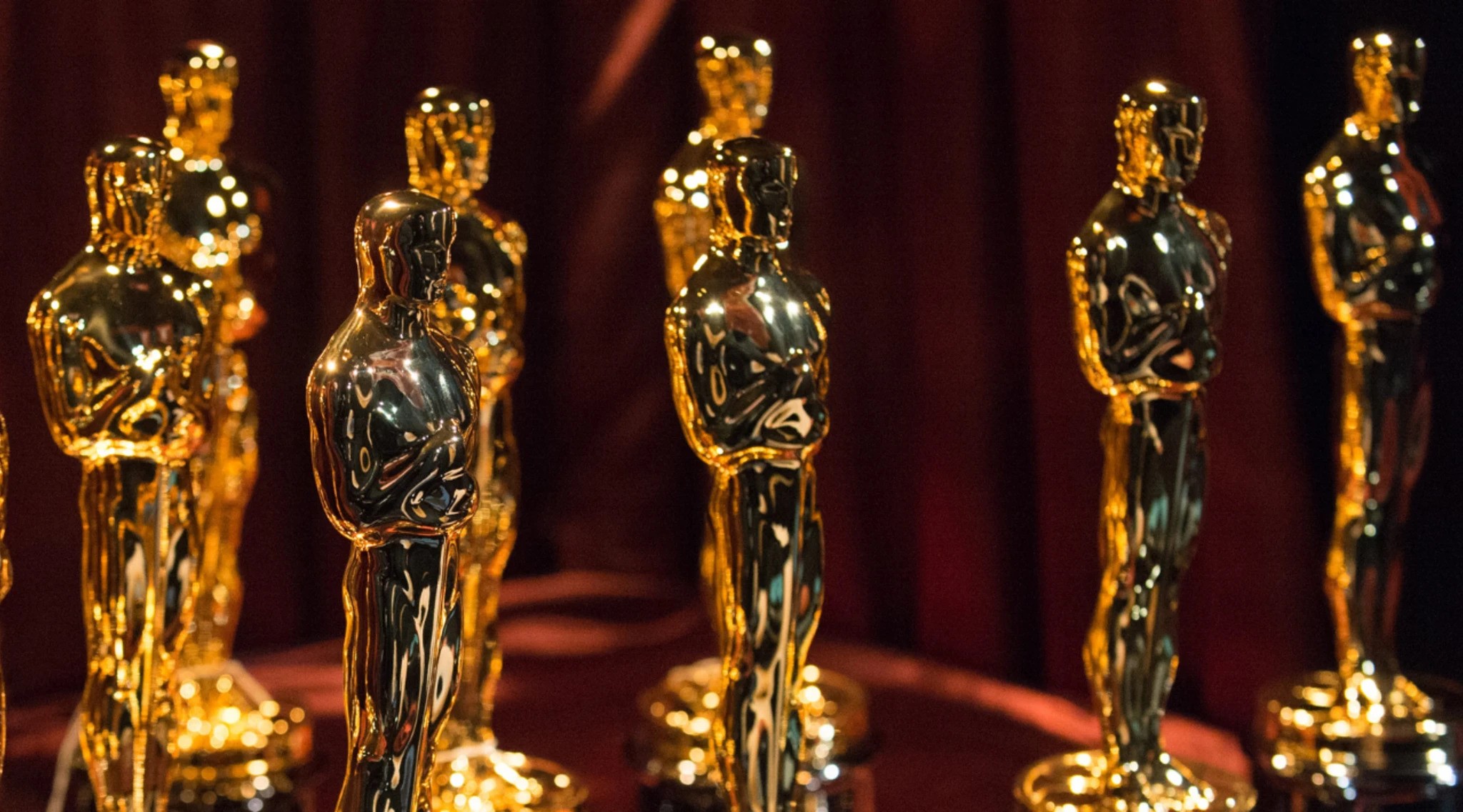 Several Academy Award statues stand together