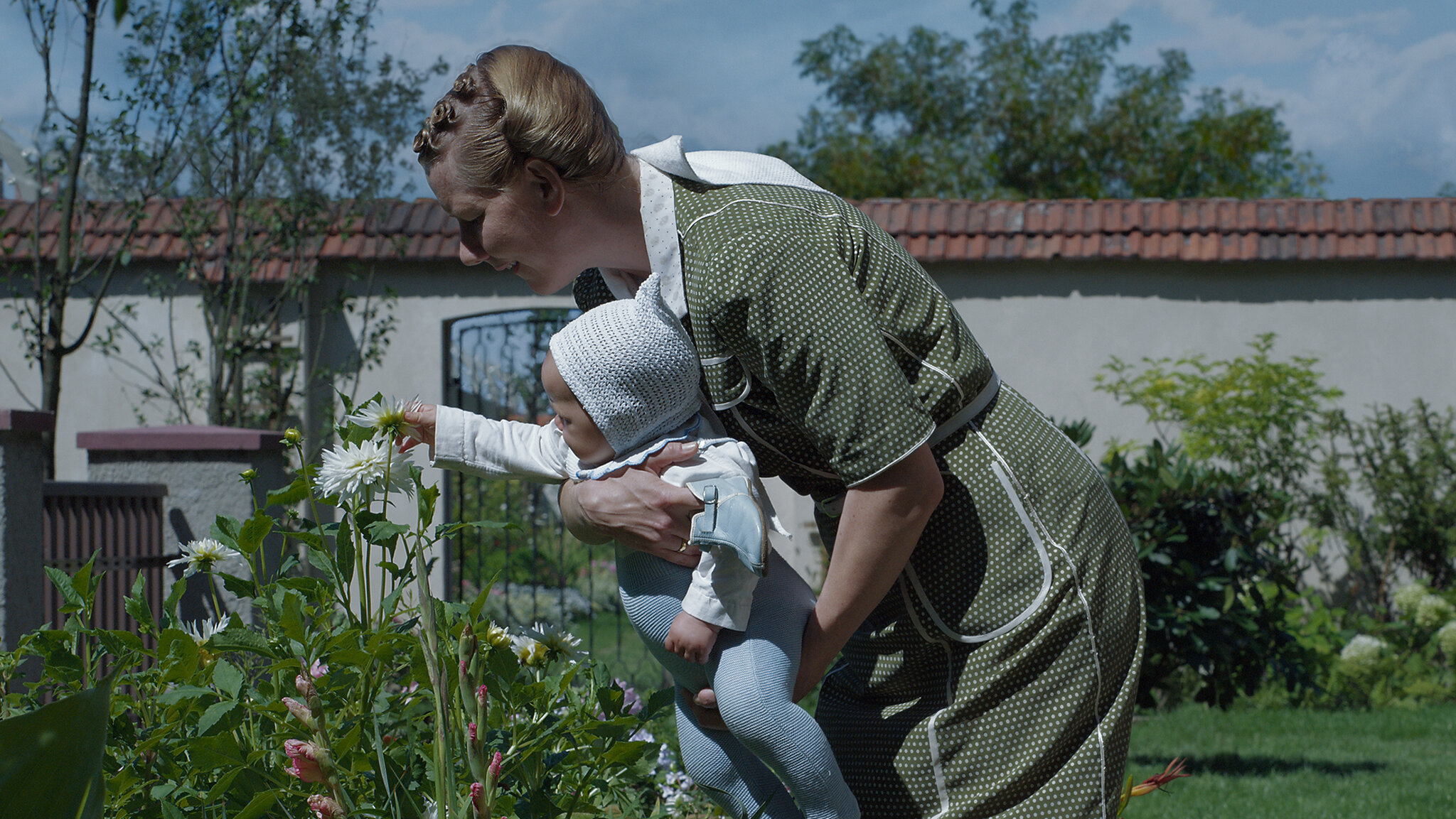 Hedwig Höss holds her child in the garden