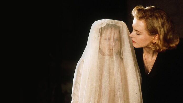 Grace looks at Anne, veiled in her communion dress