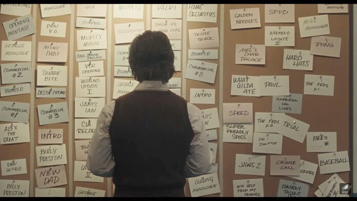 Lorne Michaels stands in front of a wall full of note cards.