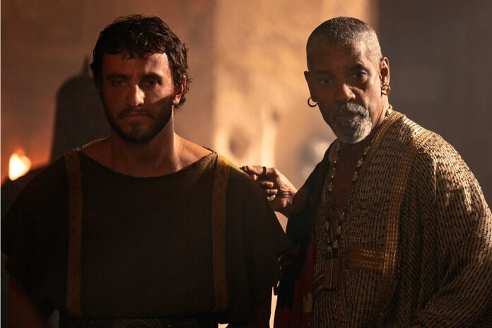 Lucius stands next to Macrinus