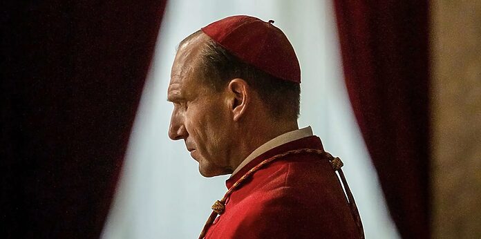 Father Lawrence closes his eyes in prayer