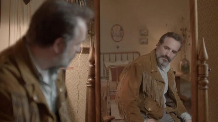 Georges looks into a mirror in Deerskin