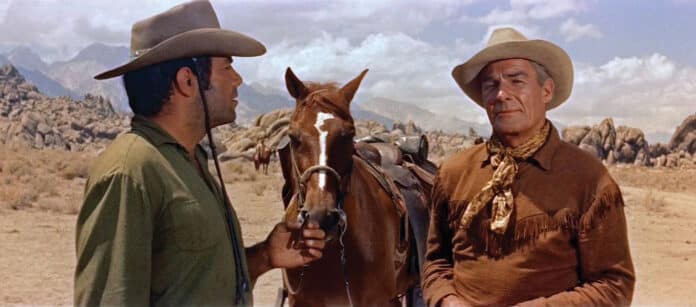 Randolph Scott as Ben Brigade and Pernell Roberts as Sam Boone stand in the desert in Ride Lonesome