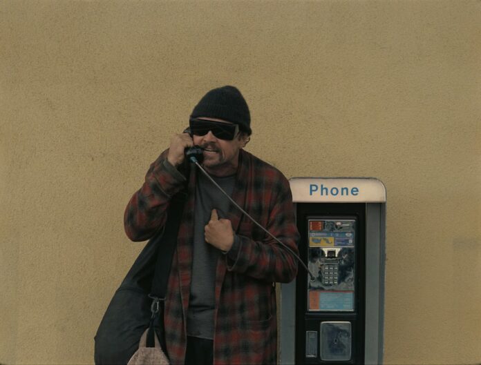 A man on a payphone