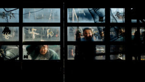 Two men look through a window in Hope