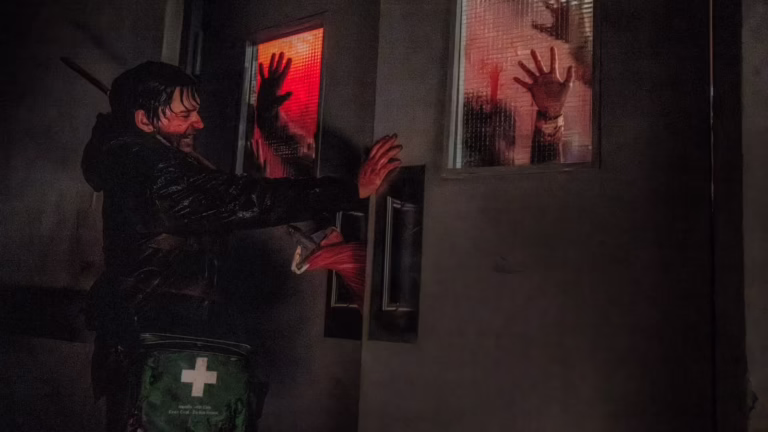 Bryan holds the doors closed against zombies