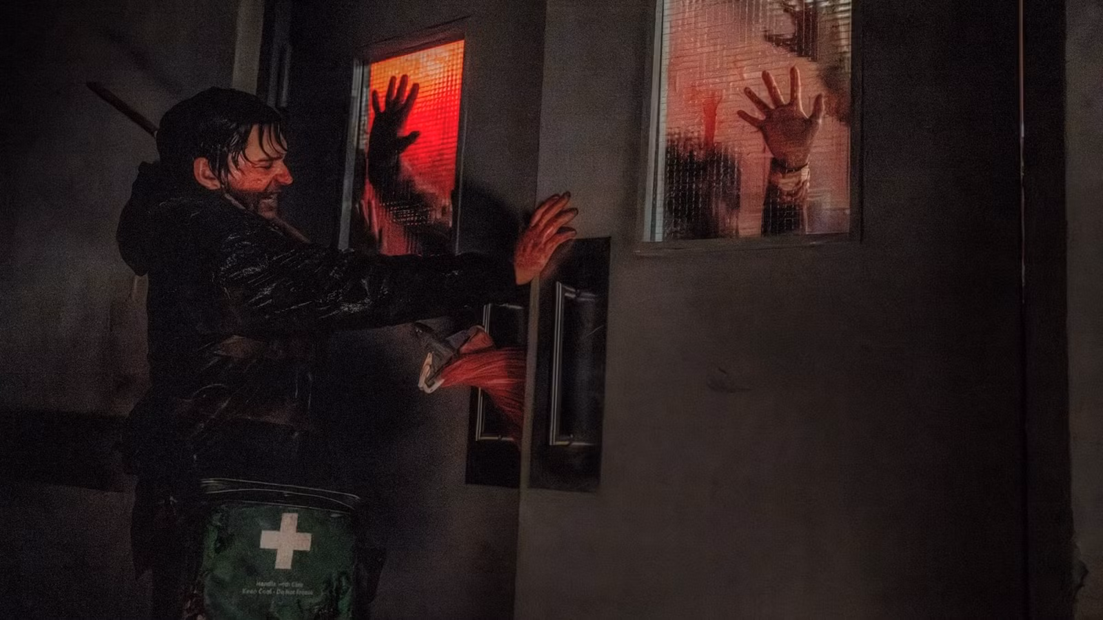 Bryan holds the doors closed against zombies